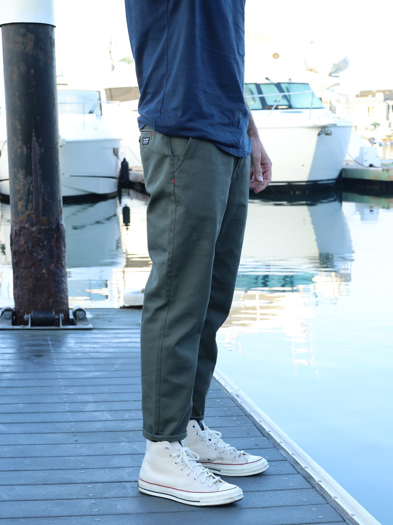 model wearing ola canvas dockside chino on boat slip in harbor